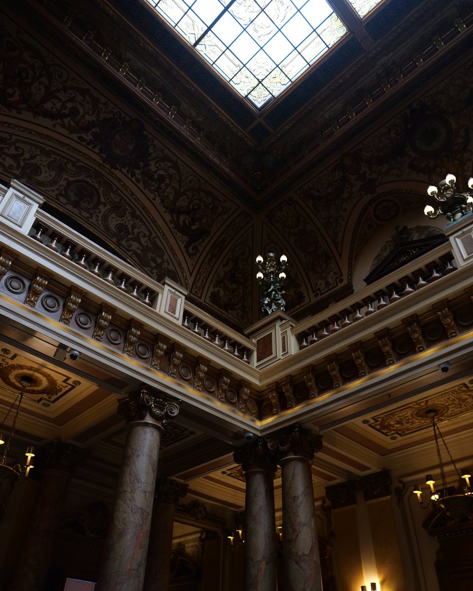 Prunkvolle Halle mit Marmorsäulen, Galerie und Glasdach, von unten fotografiert